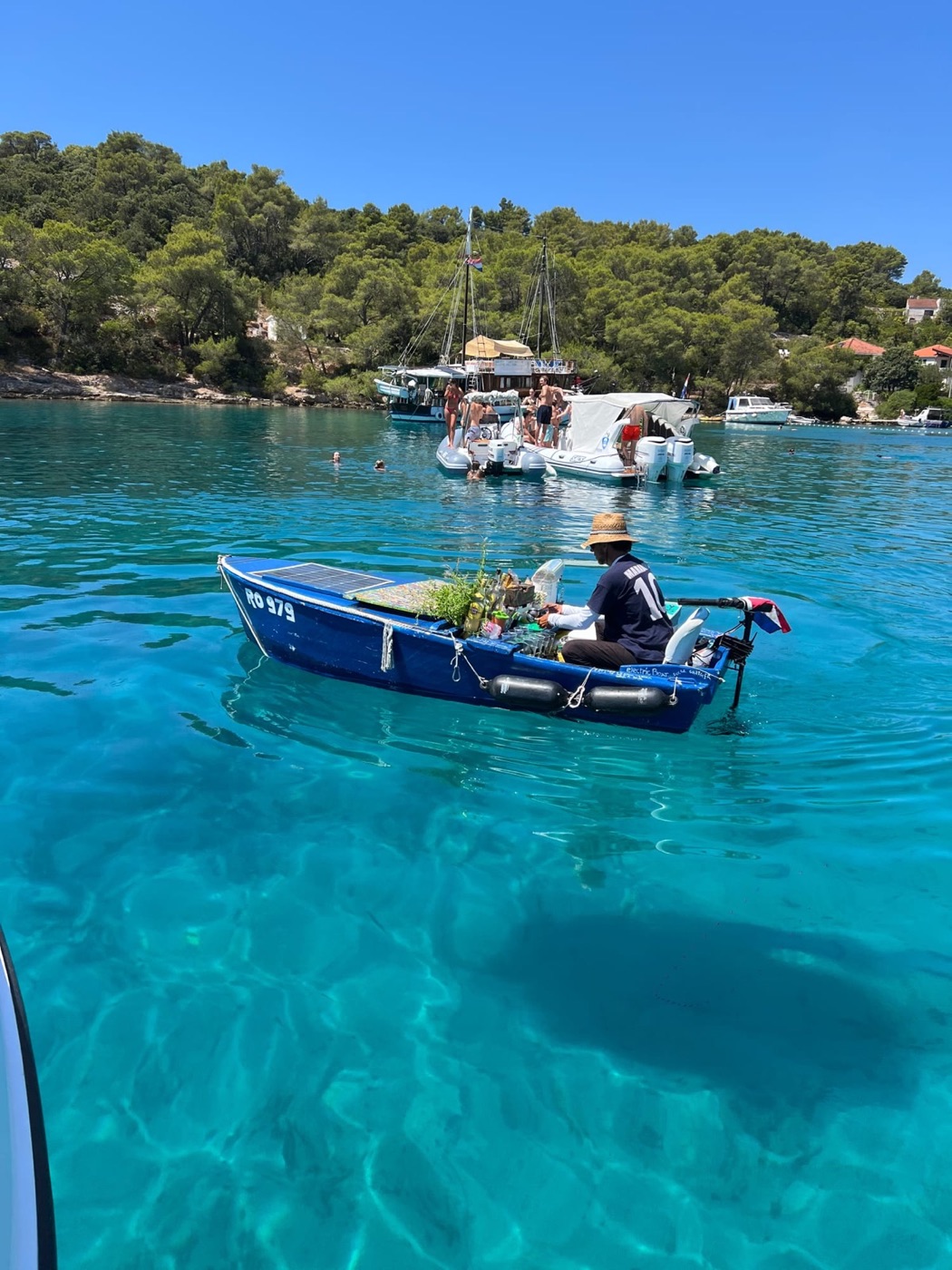 Floating bar boat in a clear Dalmatian cove
