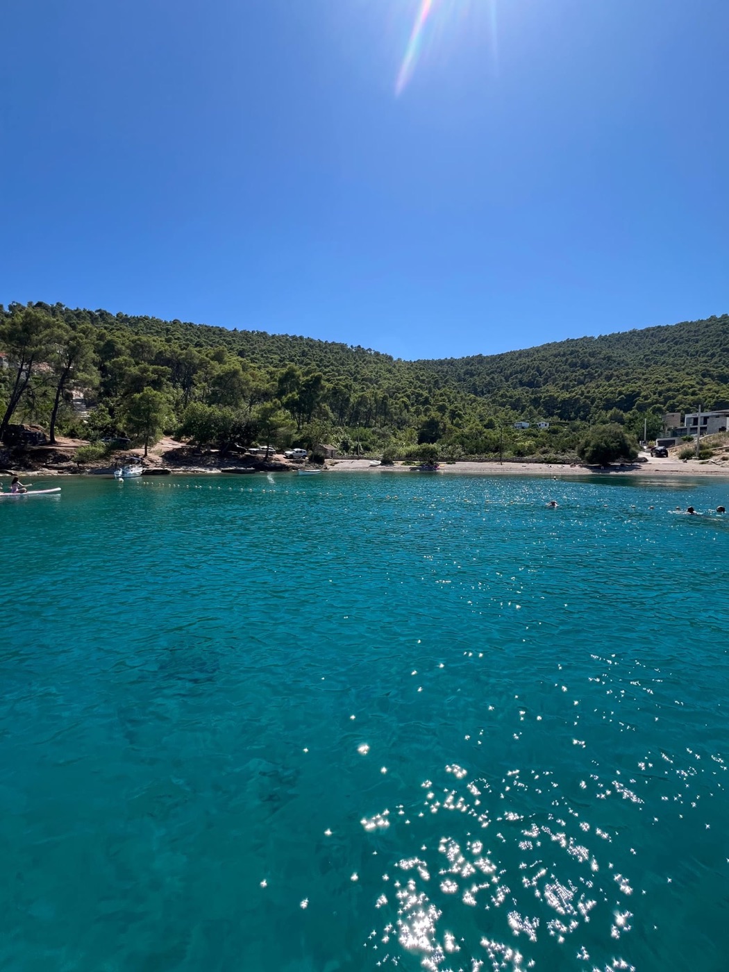 Swimmers in a turquoise bay near Split, Croatia