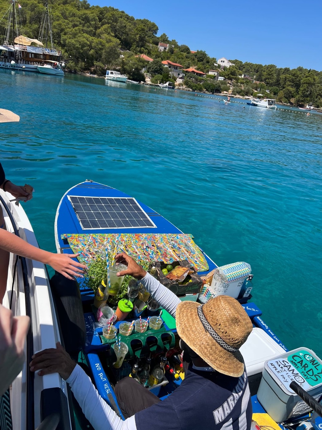 Local floating cocktail boat in a clear Adriatic bay, Croatia